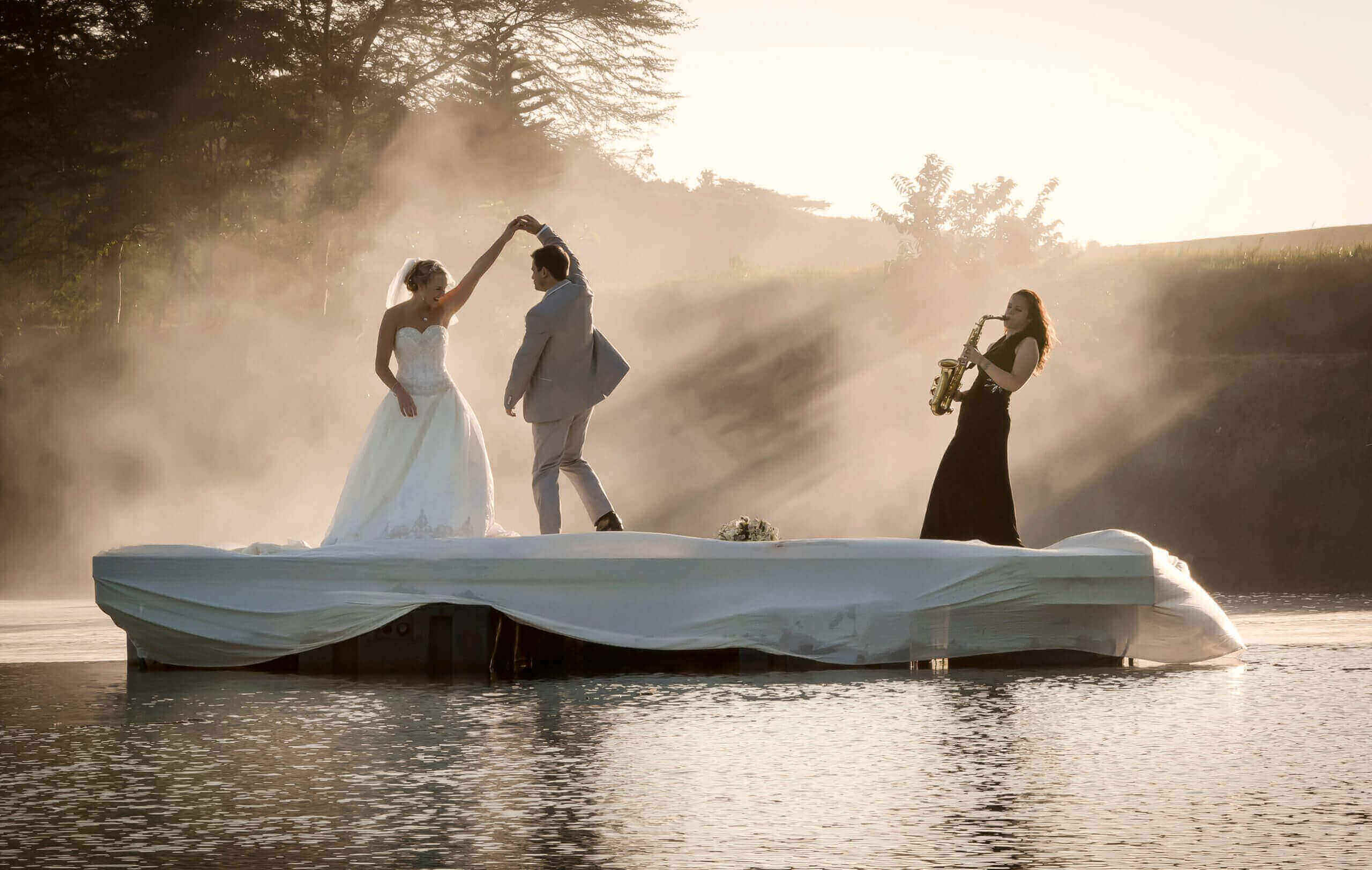 Bride and Groom Dancing on a lake to Saxophone Music